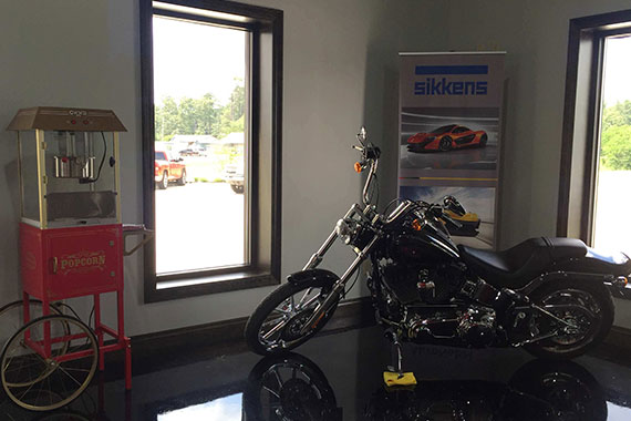 Indoor view of GT Collision & Accessories facility showing popcorn machine and motorcycle display