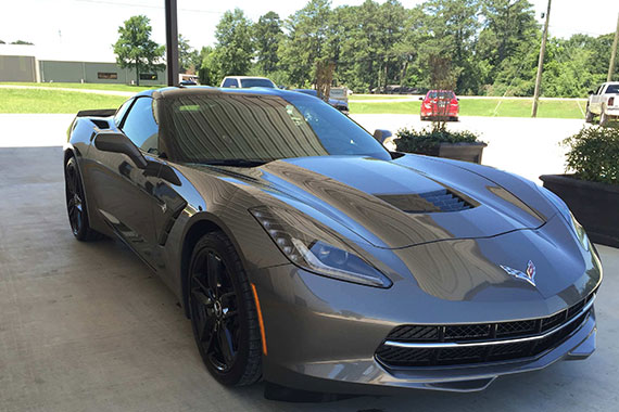 Dark grey corvette parked outside