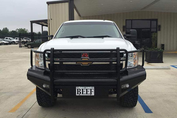 White truck with front grill addition