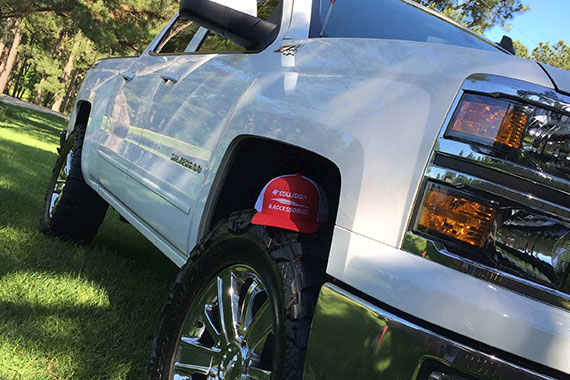 White truck with hat for sale on the tire